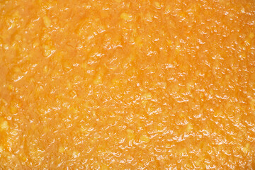 The texture of delicious orange jam.