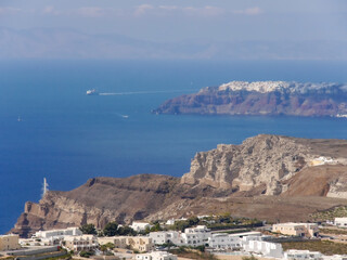 Fototapeta na wymiar View of Santorini island, sea, mountains and cities from the top of Pyrgos town.