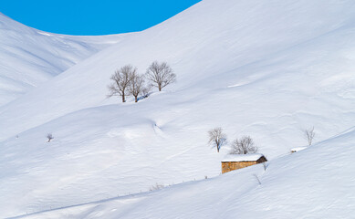 Fototapeta premium Snowy landscape in winter in the Valle del Miera in the Valles Pasiegos de Cantabria. Spain.Europe