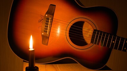 classic acoustic guitar close up in bright candlelight