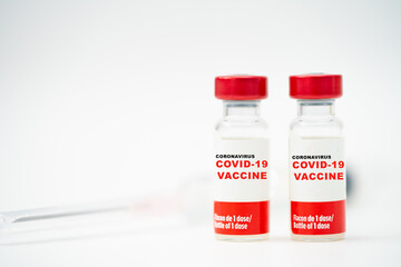 A bottle vaccine of Covid19 coronavirus vaccine in a research medical lab doctor with syringe for make injection to ill patient in medical hospital.Covid-19 coronavirus vaccine. Laboratory research.