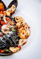 Squid ink pasta with king prawns, herbs and chilli sauce
