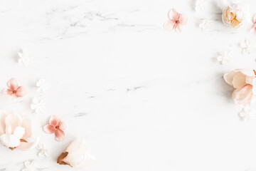 Flowers composition. White and pink flowers on marble background. Flat lay, top view