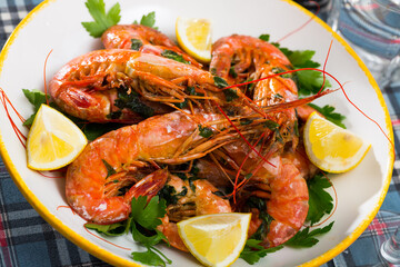 Delicious seafood dish, grilled shrimps served with parsley and lemon