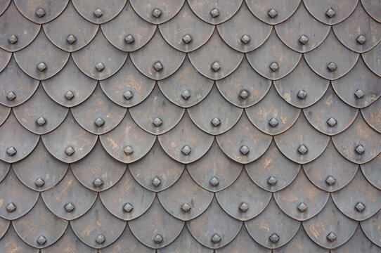 Medieval rusty metal grey scales armor background. Template for border, frame design.