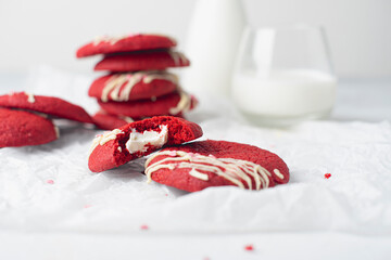 Red velvet cookies on a white plate and milk. Concept: breakfast, romance, valentines day. Copy space. Horizontal