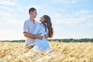 Awesome happy couple have fun in a field sunset background. Lifestyle and travel concept