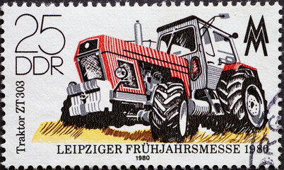 GERMANY, DDR - CIRCA 1980 : a postage stamp from Germany, GDR showing a modern large tractor "ZT 303". Leipzig Spring Fair 1980