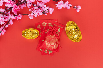 Chinese New Year Concept - Sakura Blossom, Red Envelope and Golden Ingot On Red Background