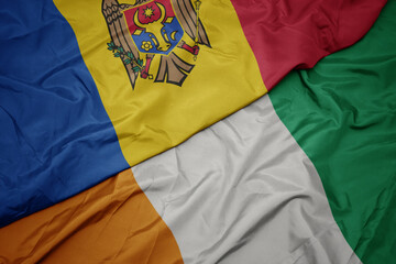 waving colorful flag of cote divoire and national flag of moldova.
