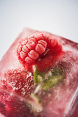 fresh raspberries frozen in ice