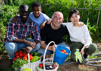 Obraz premium Portrait of friendly international family on farm field. High quality photo