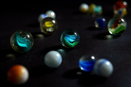 Colorful Marbles With Scattered Swirl Marbles On Dark Background