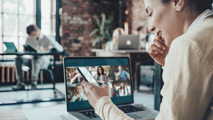 Office business teamwork concept. Pretty woman has video meeting with her remote team