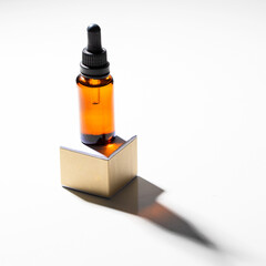 Crystal dropper bottle with essentials oil on the podium with hard shadow. Healthy skincare  and natural cosmetic  concept.