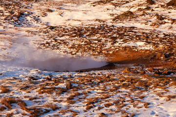 Iceland. Reykjadalur steam valley near Reykjavik, in Iceland with hills covered in white during winter