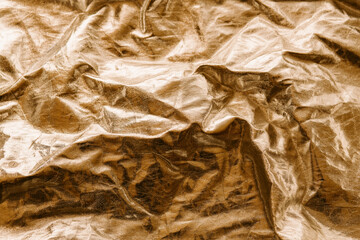Golden wrinkled paper texture and background for design.	