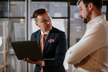 Businessmen in the office. Colleagues in conference room making a business plan. Two man working together on new project