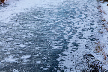 Iceland. Reykjadalur steam valley near Reykjavik, in Iceland with hills covered in white during winter