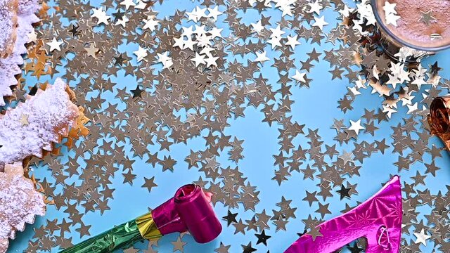 Falling confetti and sparkles. Traditional Venetian carnival and food TYPICAL. Coffee, Sfrappole or chiachiere or angel wings and aromatic coffee on a bright blue background. Copy space.