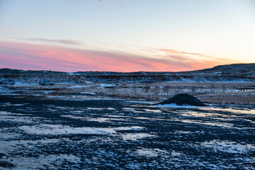 Iceland. Reykjadalur steam valley near Reykjavik, in Iceland with hills covered in white during winter