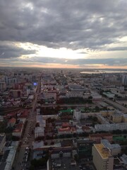 Fototapeta premium view of the city buildings and the sky from a height. High quality photo