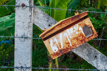Old mailboxes on barbed wire