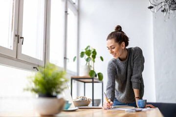 Young female freelancer working in loft office
