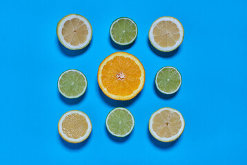 Orange, lime and lemon slices on a blue background. CITRUS CITRIC