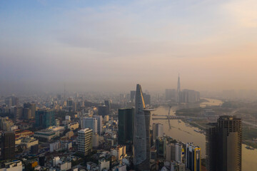 Heart of Saigon or Ho Chi Minh City Skyline, Vietnam aerial view at Golden hour with landmark buildings and river