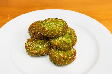 Fried meatballs of peas and broccoli in a white dish