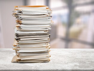Stack of document papers on stone desk