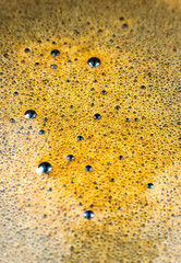 Brown coffee foam texture background in cup, close up, macro photo.