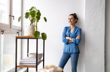 Portrait of a smiling creative woman in a modern loft space
