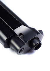 Barrel of a black gun, pistol lies on a white background. Close up.
