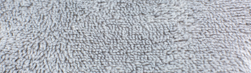 Grey cotton towel or carpet.fluffy texture background. Close up photo.