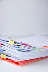 Close-up of a set of sheets attached by clips and clamps. Vertical photography. Information overload concept