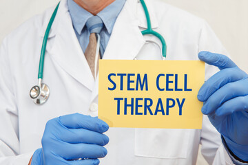 Close-up of a male doctor holding a sign with the text STEM CELL THERAPY