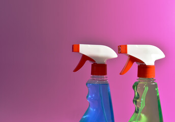 Detergent spray cleaner on purple background. Detergents for washing windows and cleaning dishes. Concentrated and anti-bacterial liquids for remove carbon, grease and dirt