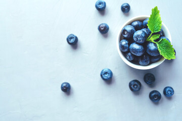 Fresh blueberries in a white bowl. Close up, top view.