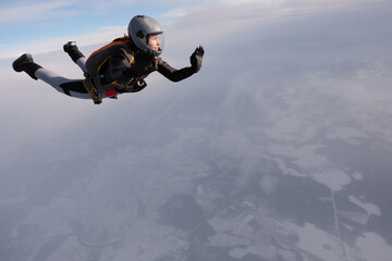 Skydiving. A pretty girl is flying in the sky.