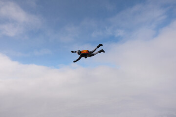 Skydiving. A skydiver is flying in the sky.