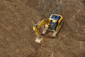 Excavator on earthworks. Backhoe on groundwork for road construction. Digger at construction site....