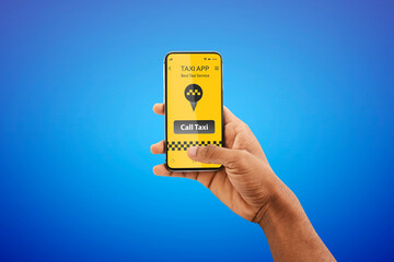 City taxi service app. Unrecognizable black man booking cab online via mobile application over blue studio background