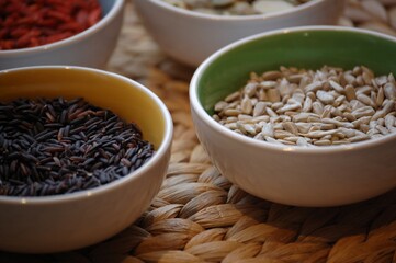 A healthy meal, simple ingredients: goji berries, black rice. Photo taken on a bamboo mat.