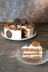 Sponge cake with cream cheese on a wooden background. Selective focus.