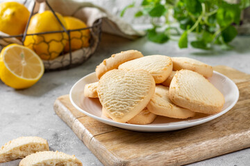 Lemon cookies. Lemon Heart cookies in a white plate on the light gray kitchen table. Cookies for Valentine's Day