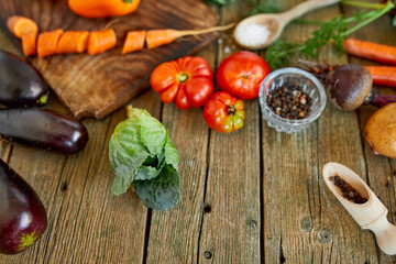 Flat lay of various organic vegetables ingredients and spicy on wooden background, local food, Vegetarian and vegan food, diet spring concept, top view, copy space.