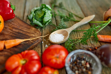 Flat lay of various organic vegetables ingredients and spicy on wooden background, local food, Vegetarian and vegan food, diet spring concept, top view, copy space.