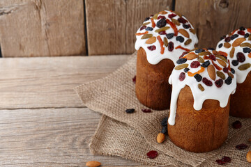 Easter cakes with candied fruits and nuts on wooden background